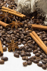 Roasted coffee beans, cinnamon and star anise on  table