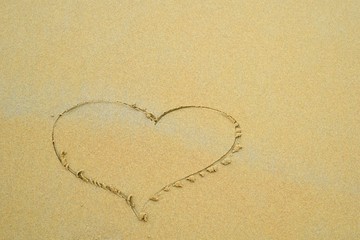 Fototapeta na wymiar Heart on a sand