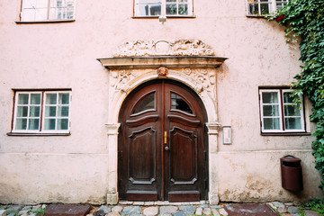 Fototapeta na wymiar Riga Latvia. Wooden Door Of Portal Decorated By Molding On Facade