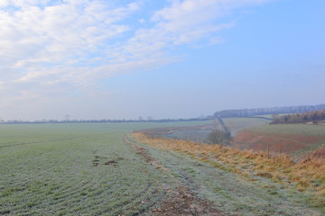 Frosted grasses above a scenic valley in an English winter landscape