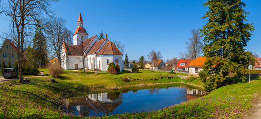 Fototapeta premium Traditional local Estonian Lutheran church. White stone and red tile roof.