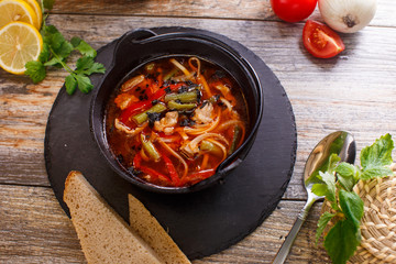 Hot goulash soup in a black pot