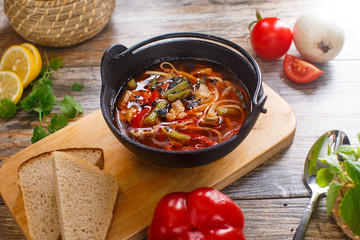 Hot goulash soup in a black pot