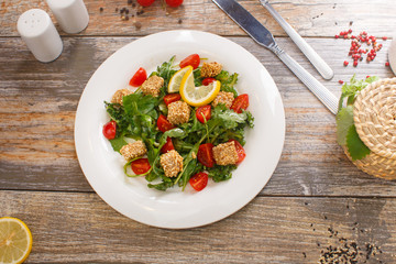 salad of arugula with cherry tomatoes and croutons