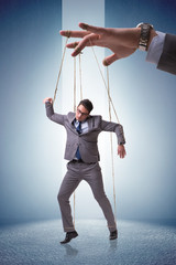 Businessman puppet being manipulated by boss