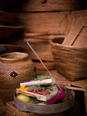 Balinese Hindu offering blessing insense stick with colourful flowers - Bali, indonesia