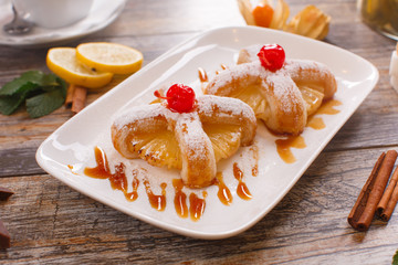 Baked buns with a cherry and pineapple