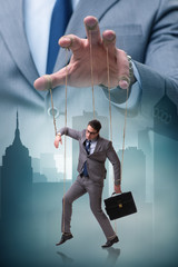 Businessman puppet being manipulated by boss