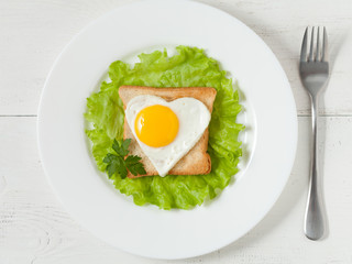 Concept of healthy breakfast or lunch slice of wholewheat toast with fried egg, salad on white background. Flat lay. Top view.