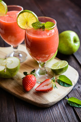 Fresh organic smoothie with apple, strawberry and lime