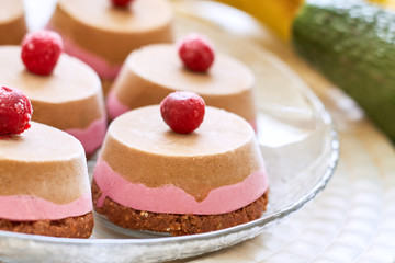 Raw vegan dessert with sour cherry served on glass plate
