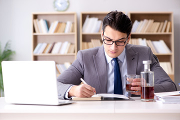 Young businessman drinking from stress