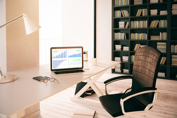 Laptop with business charts