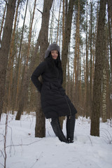 girl in a fur coat in the winter in the Park the sun