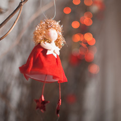 Red angel with star on a red garland background