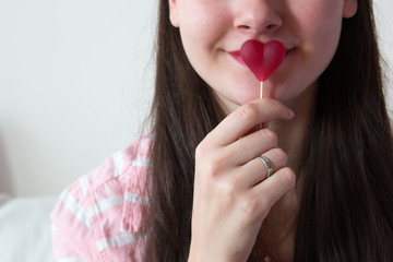 Girl with heart shape candy in Valentine's Day