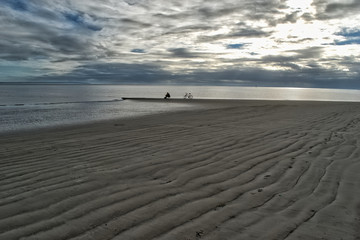 person contemplating sunset on a beach