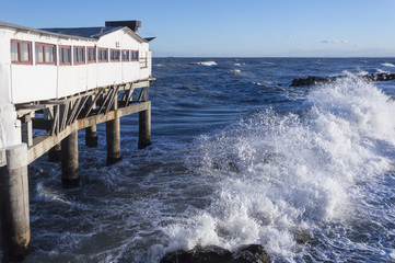 Rough sea with white house in Adriatic sea, Italy