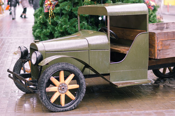 Front view of vintage classic american car parked in a street of Old Havana with new year tree and...