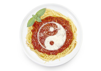 Dish of pasta with parmesan cheese shaped as a Ying Yang symbol.