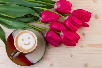 Coffee and red tulips on wooden background. Top view