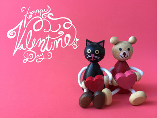 Happy Valentine's Day word and couple wood toys bear and black cat on pink background