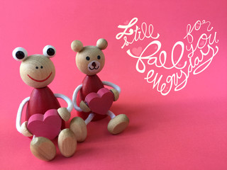 I still fall for you everyday word and couple wood toys bear and frog on pink background