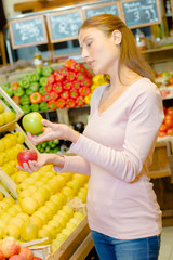 woman choosing apples