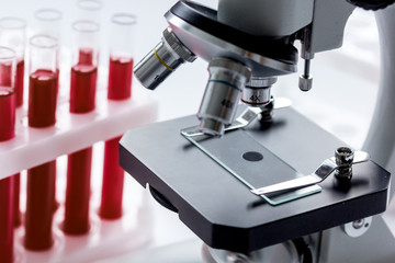 close up macro microscope with blood sample on white background
