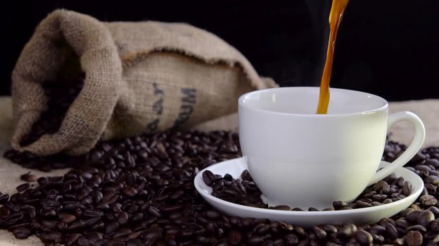 pouring fresh tasty coffee into cup