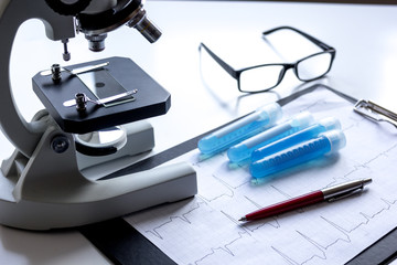 doctors desk with microscope and test tubes
