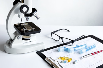 doctors desk with microscope and test tubes