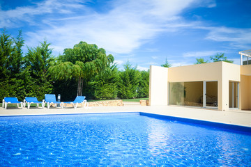 Blue water of outdoor swimming pool luxury lifestyle background