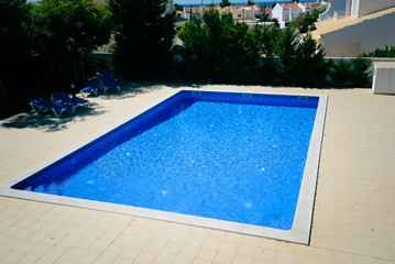 Blue water of outdoor swimming pool luxury lifestyle background