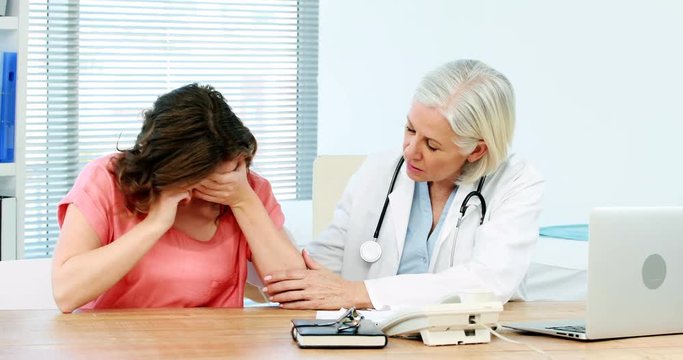 Female doctor consoling a patient