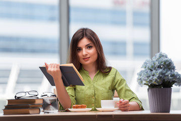 Young student preparing for exams drinking tea