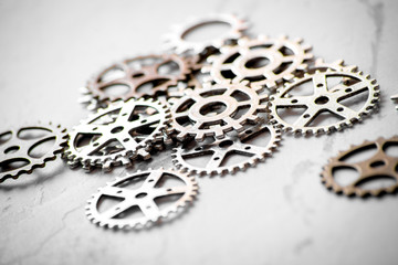 concept hour metal gears on gray background top view