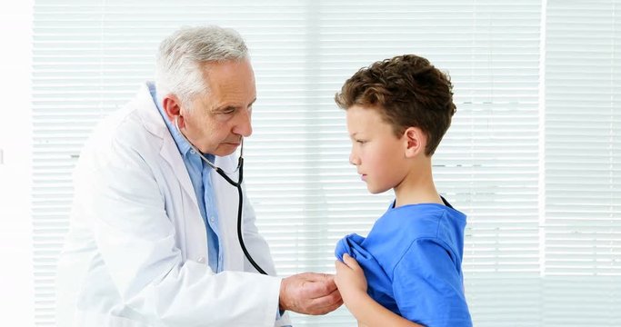 Male doctor examining a boy