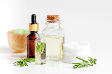 organic cosmetics with extracts of herbs rosemary on white background