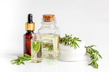 organic cosmetics with extracts of herbs rosemary on white background