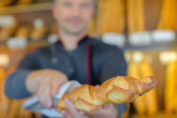 baker showing a french baguette