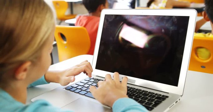 Girl using laptop in classroom