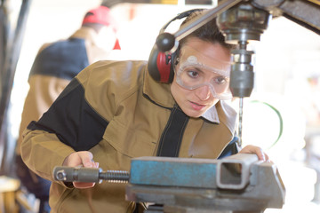 pretty employee milling at the factory