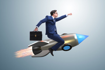 Businessman flying on rocket in business concept