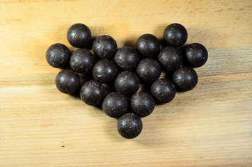 Chocolate balls lying in a form of heart