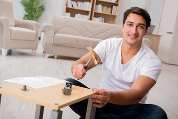 Man assembling shelf at home