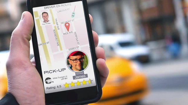 A man uses a ride-sharing app on his cellular phone to call a driver.  	