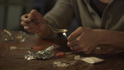 Impatient drug addict withdrawing heroin dose from spoon with syringe, sequence - Powered by Adobe