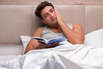 Man reading book in the bed