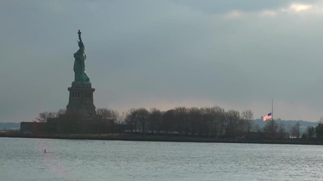 Statue of Liberty and half flag